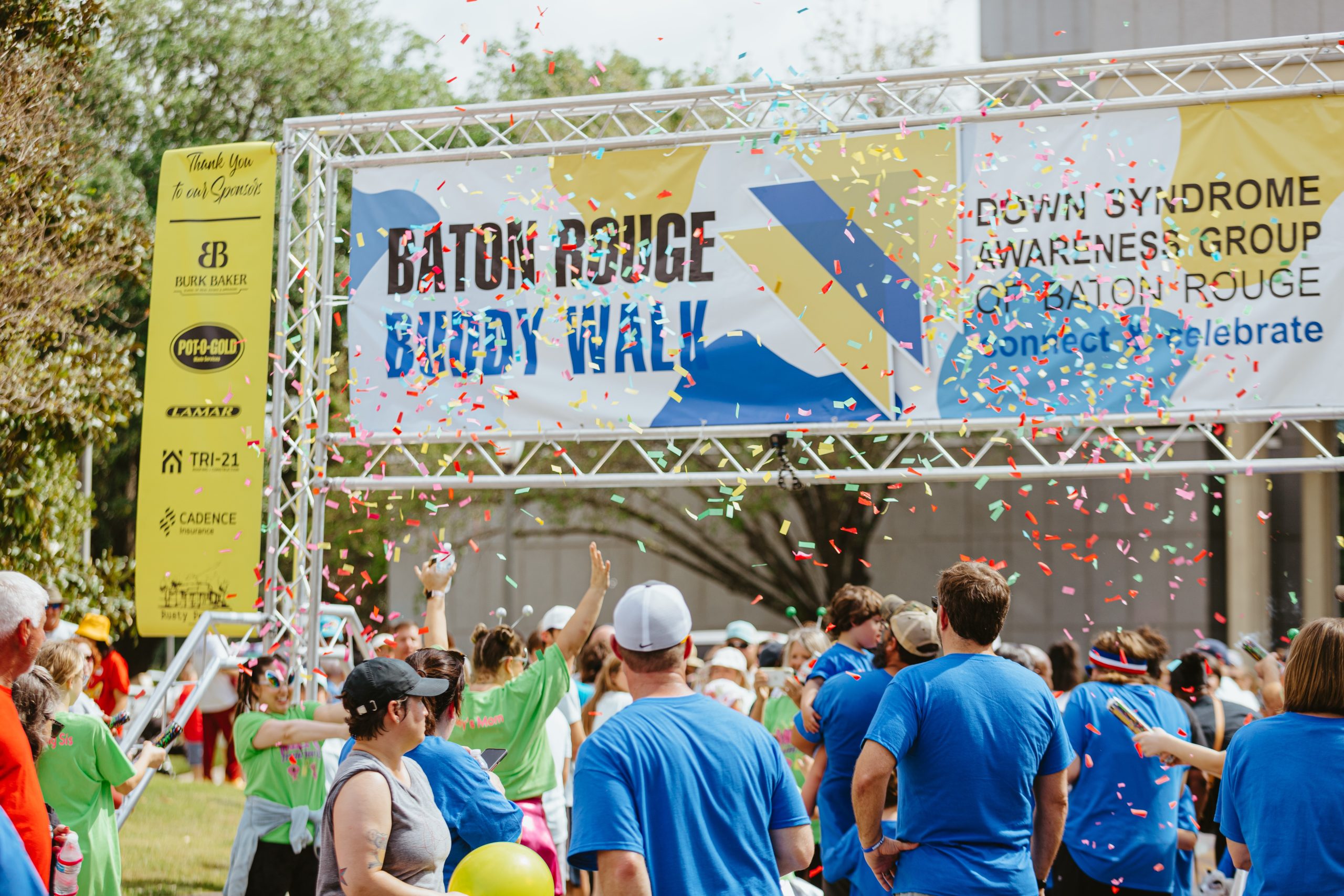 Confetti cannons in front of buddy walk banner, 2024 Buddy Walk Sponsor Registration